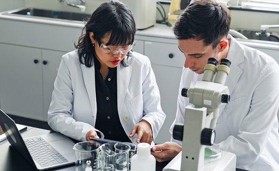 Male and female scientist talking to each other
