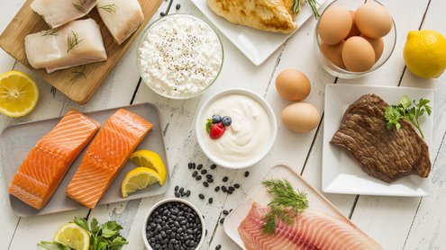 Fish, eggs, meat, yoghurt and cottage cheese on one table