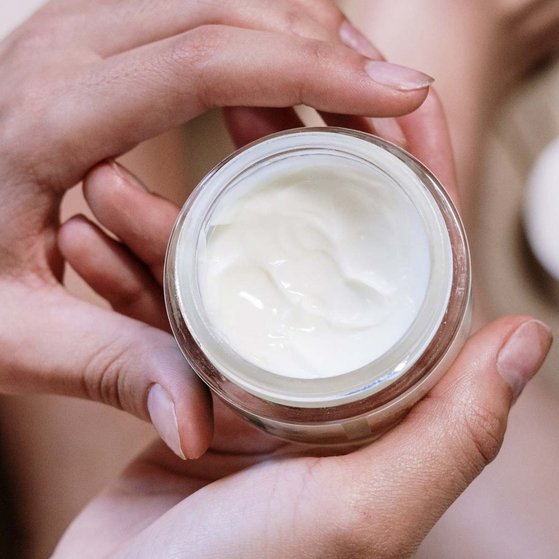 Cremedose Person is holding a lotion container