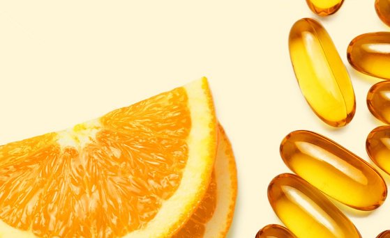 Bilder von Orangen-Scheiben und Vitaminpillen.